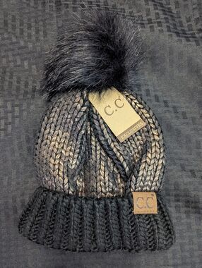 Black And Copper Foil C.C. Fur Pom Pom Cable Knit Beanie.